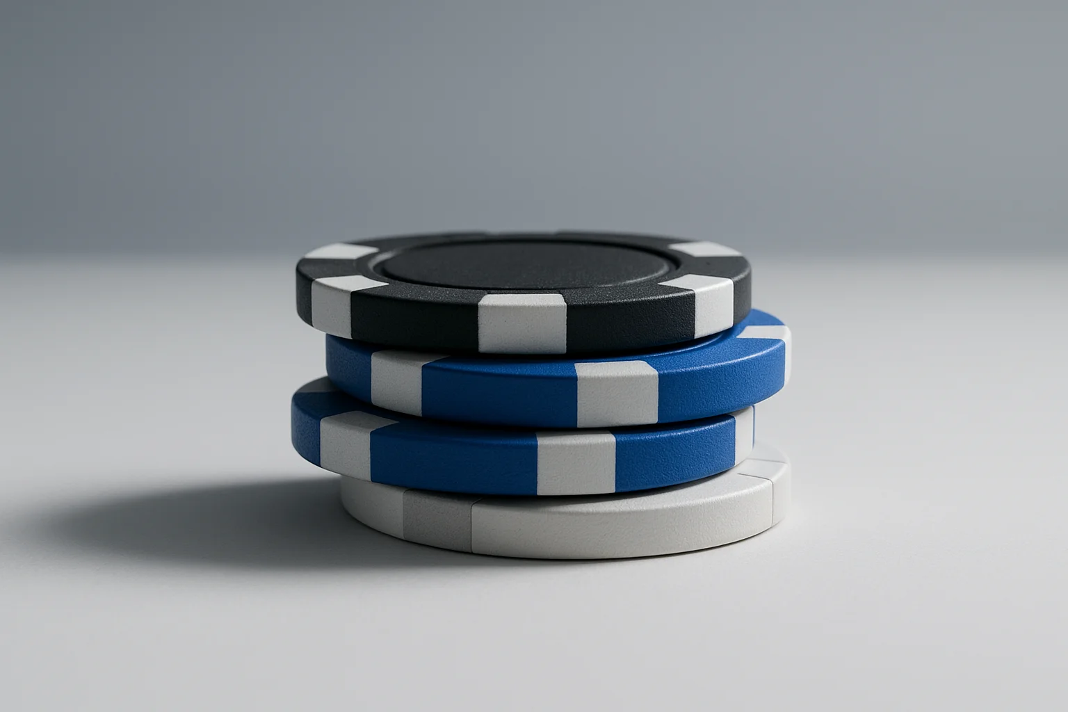 Three poker chip denominations stacked on white background with subtle shadows
